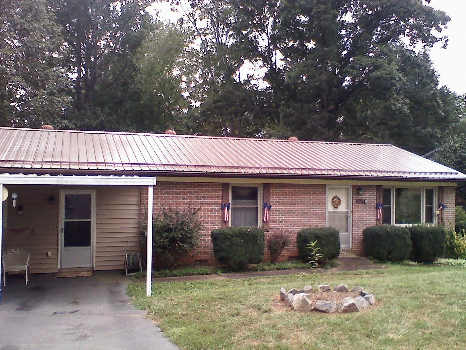 Bronze metal roof and carport on a brick ranch home — Roof Repair work by our crew in Linthicum Heights