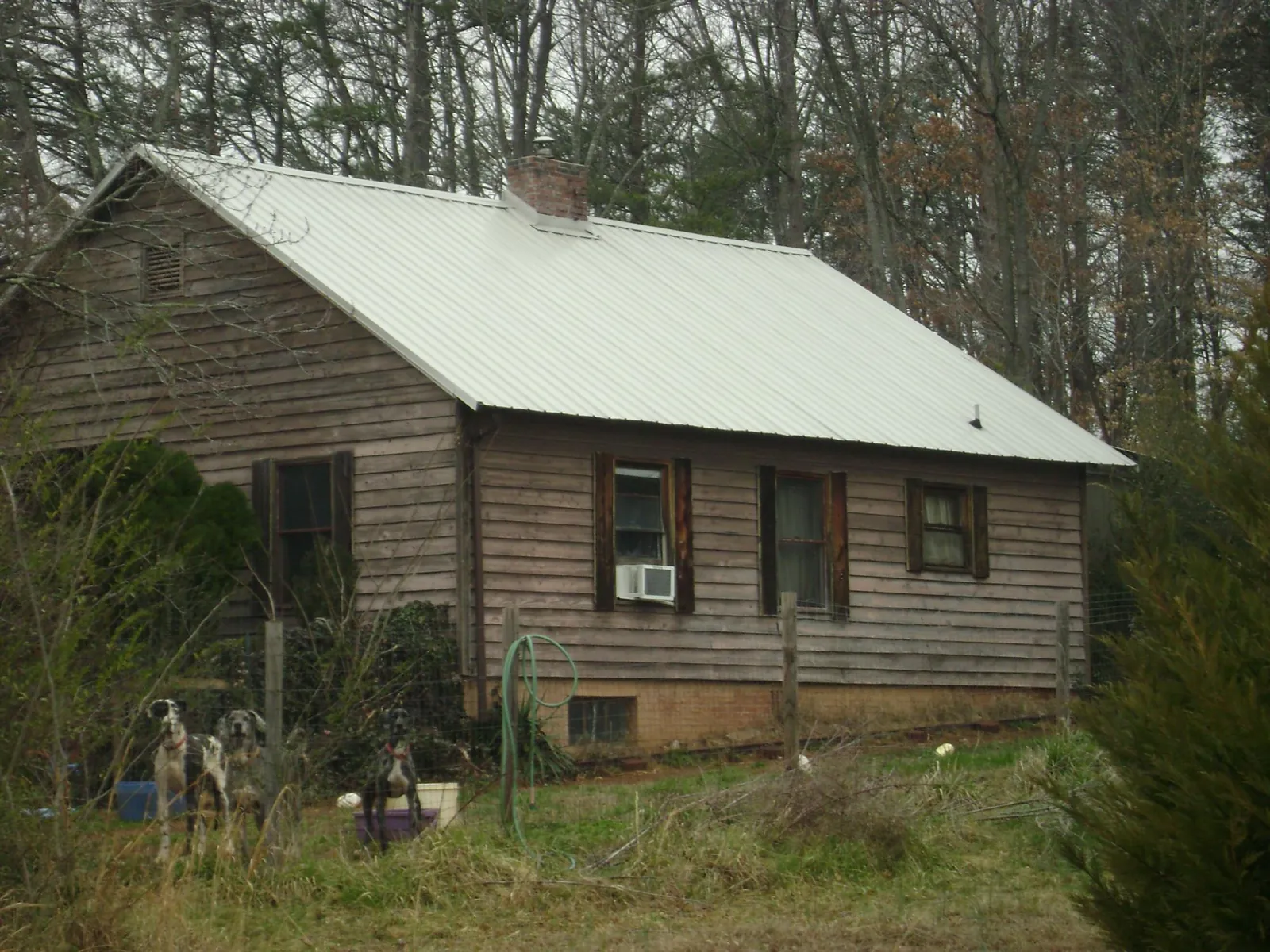 White metal roof on an old wood sided farmhouse, from a Asphalt Shingle Roof Repair job in Linthicum Heights